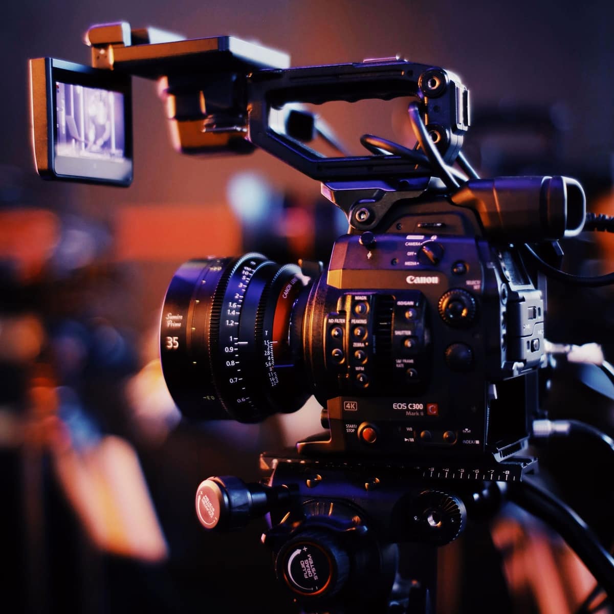 Videographer capturing event on cinema camera