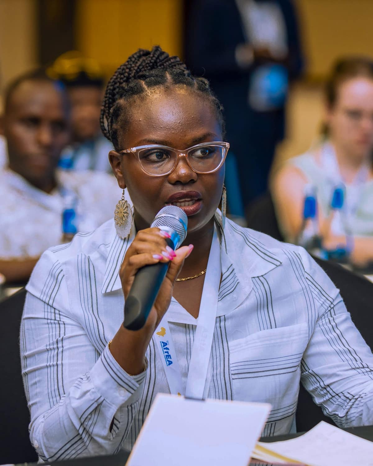 Black professional presenting at corporate event — Kampala